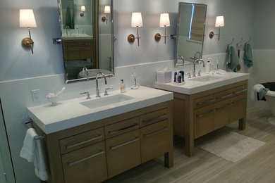Bathroom - small contemporary 3/4 porcelain tile bathroom idea in Miami with an undermount sink, flat-panel cabinets, medium tone wood cabinets, quartz countertops and blue walls