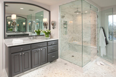 Example of a mid-sized transitional master white tile and porcelain tile corner shower design in Chicago with raised-panel cabinets, gray cabinets, quartz countertops, white walls and an undermount sink