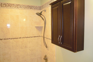 Example of a classic master beige tile and ceramic tile bathroom design in Newark with an undermount sink, raised-panel cabinets, dark wood cabinets, a one-piece toilet, green walls and granite countertops