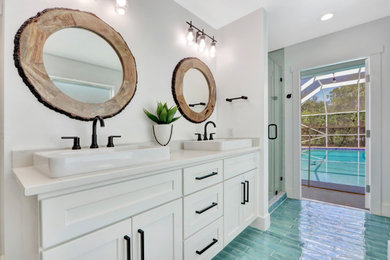 This is an example of a large contemporary bathroom in Miami with shaker cabinets, white cabinets, white walls, blue floors, a hinged door, white worktops, double sinks, a built in vanity unit, an alcove shower and a vessel sink.