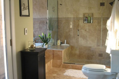 Example of a mid-sized classic beige tile and ceramic tile bathroom design in Houston with a vessel sink, raised-panel cabinets, medium tone wood cabinets and granite countertops