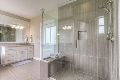 Inspiration for a mid-sized transitional master corner shower remodel in Seattle with shaker cabinets, white cabinets, beige walls, an undermount sink and a hinged shower door