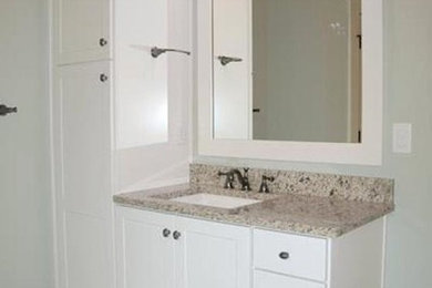 Bathroom photo in Charlotte with a drop-in sink and white cabinets