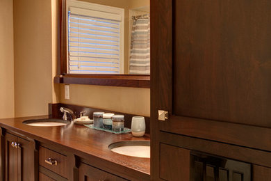 Inspiration for a mid-sized transitional bathroom remodel in Milwaukee with an undermount sink, shaker cabinets, dark wood cabinets and wood countertops