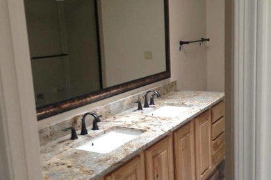 Inspiration for a large master multicolored tile bathroom remodel in Phoenix with an undermount sink, raised-panel cabinets, light wood cabinets, granite countertops and beige walls