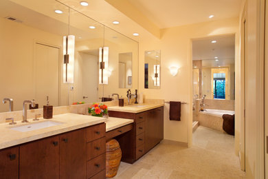 Example of a mid-sized trendy master travertine floor drop-in bathtub design in San Francisco with flat-panel cabinets, dark wood cabinets, an undermount sink, marble countertops and a hinged shower door