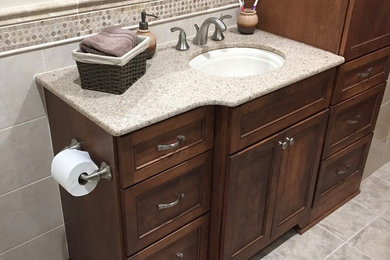 Bathroom - mid-sized traditional master gray tile, white tile and stone slab ceramic tile and gray floor bathroom idea in New York with dark wood cabinets, a one-piece toilet, white walls, soapstone countertops, recessed-panel cabinets and an undermount sink