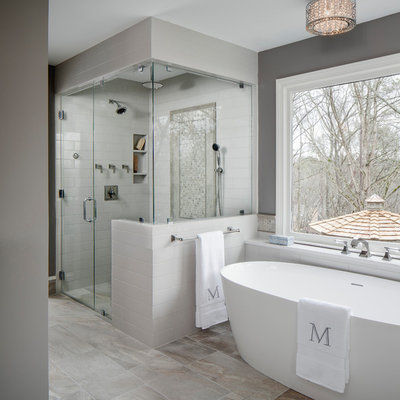 Inspiration for a large transitional master gray tile and ceramic tile porcelain tile and gray floor bathroom remodel in Atlanta with gray walls, a hinged shower door, flat-panel cabinets, gray cabinets, a two-piece toilet, an undermount sink and quartz countertops