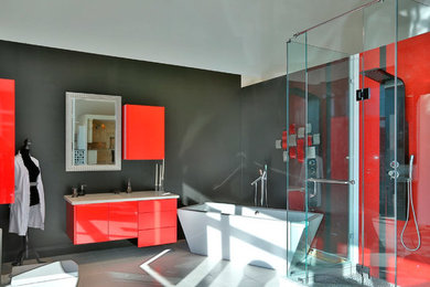 На фото: главная ванная комната среднего размера в стиле модернизм с плоскими фасадами, красными фасадами, столешницей из искусственного кварца, отдельно стоящей ванной, угловым душем, серой плиткой и серыми стенами с