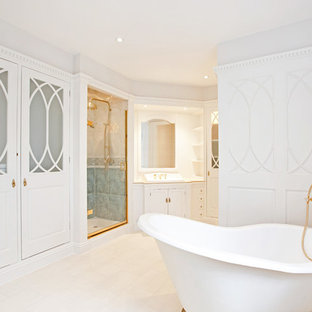 Inspiration for a large timeless bathroom remodel in London with beaded inset cabinets, white walls, white cabinets, a drop-in sink and a hinged shower door