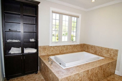 Inspiration for a transitional master drop-in bathtub remodel in Baltimore with dark wood cabinets