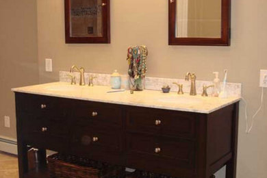 Example of a huge master brown tile and stone tile pebble tile floor bathroom design in Philadelphia with furniture-like cabinets, dark wood cabinets, granite countertops, beige walls and an undermount sink