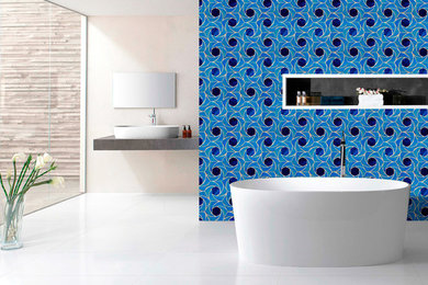 This is an example of a medium sized modern ensuite bathroom in Gold Coast - Tweed with blue walls, mosaic tiles, beaded cabinets, white cabinets, a built-in bath, a corner shower, a one-piece toilet, green tiles, porcelain flooring, a built-in sink, solid surface worktops, white floors, an open shower and grey worktops.
