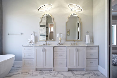 Minimalist master marble floor and white floor freestanding bathtub photo in Other with raised-panel cabinets, white cabinets, gray walls, an undermount sink and quartz countertops