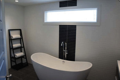 Mid-sized trendy master white tile and subway tile freestanding bathtub photo in New York with white walls