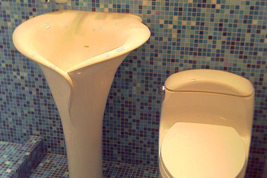 Example of a small trendy blue tile and mosaic tile mosaic tile floor powder room design in New York with a pedestal sink, a one-piece toilet and multicolored walls
