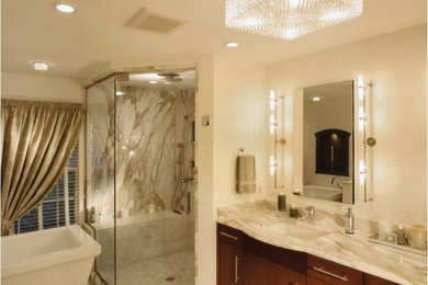 Inspiration for a large contemporary ensuite bathroom in Cleveland with flat-panel cabinets, dark wood cabinets, a freestanding bath, a corner shower, white walls, a submerged sink, marble worktops, stone slabs and porcelain flooring.