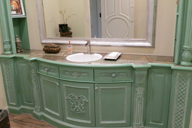 Example of a classic 3/4 bathroom design in Orange County with recessed-panel cabinets and green cabinets
