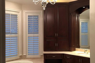 Elegant master bathroom photo in Jacksonville with recessed-panel cabinets and dark wood cabinets