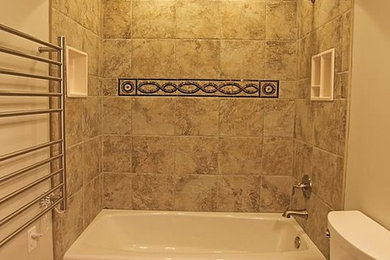 Tub/shower combo - small modern master brown tile and ceramic tile ceramic tile tub/shower combo idea in New York with brown cabinets, a two-piece toilet, beige walls and granite countertops