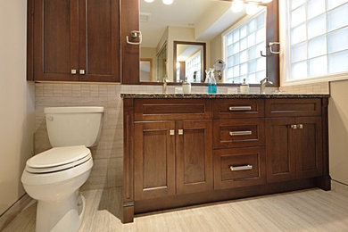 Bathroom - large transitional master beige tile and ceramic tile ceramic tile bathroom idea in Calgary with shaker cabinets, dark wood cabinets, a two-piece toilet, beige walls, an undermount sink and quartzite countertops