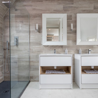 Inspiration for a large contemporary grey and white shower room bathroom in Sussex with flat-panel cabinets, white cabinets, a corner shower, beige tiles, white walls, white floors, an open shower, white worktops, double sinks and a built in vanity unit.