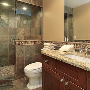 Design ideas for a large traditional 3/4 bathroom in Phoenix with shaker cabinets, dark wood cabinets, an alcove shower, a one-piece toilet, multi-coloured tile, slate, beige walls, slate floors, an undermount sink and granite benchtops.