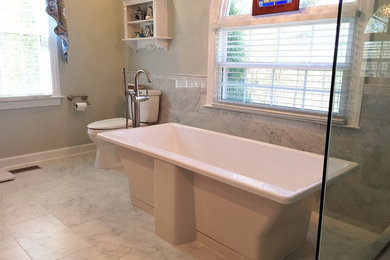 Example of a mid-sized classic master white tile and stone tile marble floor bathroom design in Raleigh with raised-panel cabinets, medium tone wood cabinets, a one-piece toilet, green walls, an undermount sink and granite countertops