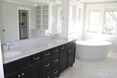 This is an example of a large modern ensuite bathroom in Nashville with recessed-panel cabinets, dark wood cabinets, marble worktops, white tiles and travertine flooring.