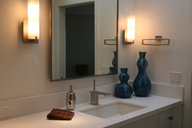 Example of a mid-sized trendy master white tile bathroom design in Portland with an undermount sink, flat-panel cabinets, white cabinets, quartz countertops and white walls