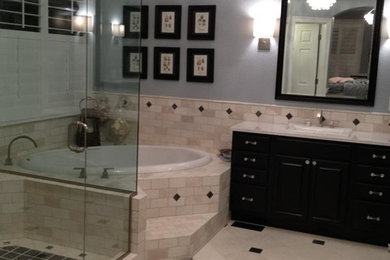 Example of a large classic master beige tile and stone tile marble floor bathroom design in Denver with a drop-in sink, raised-panel cabinets, black cabinets, quartzite countertops and blue walls