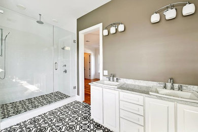 Mid-sized elegant master mosaic tile floor and multicolored floor corner shower photo in New Orleans with raised-panel cabinets, white cabinets, beige walls, an integrated sink, marble countertops and a hinged shower door