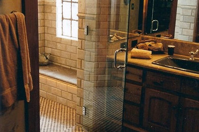 Doorless shower - stone tile mosaic tile floor doorless shower idea in Other with granite countertops