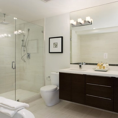 Trendy beige tile alcove shower photo in Other with an undermount sink, flat-panel cabinets and black cabinets