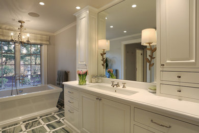 Inspiration for a timeless freestanding bathtub remodel in Portland with flat-panel cabinets, white cabinets and gray walls