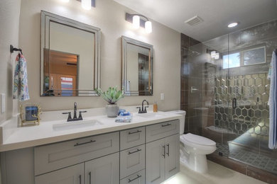 Mid-sized trendy 3/4 porcelain tile and beige floor alcove shower photo in Other with shaker cabinets, gray cabinets, a two-piece toilet, gray walls, an undermount sink, quartz countertops, a hinged shower door and white countertops