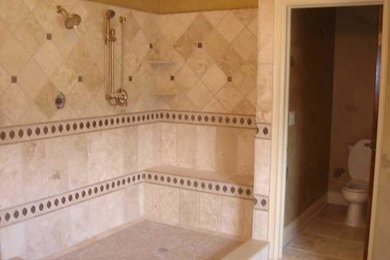 Doorless shower - master beige tile and ceramic tile ceramic tile doorless shower idea in DC Metro with a one-piece toilet and yellow walls