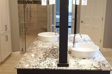 Example of a trendy porcelain tile porcelain tile walk-in shower design in St Louis with a vessel sink and granite countertops