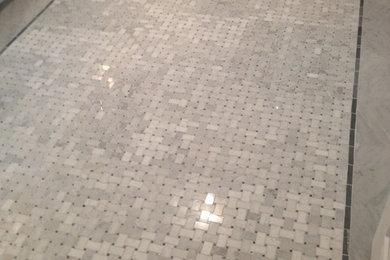 Elegant stone tile marble floor bathroom photo in New Orleans