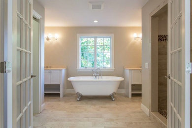 Transitional master white tile and porcelain tile light wood floor freestanding bathtub photo in New York with an integrated sink, louvered cabinets, gray cabinets, solid surface countertops and beige walls