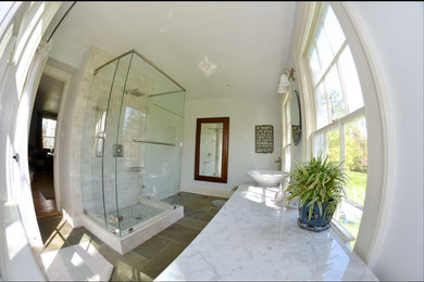 Example of a mid-sized transitional 3/4 multicolored tile, white tile and stone tile ceramic tile doorless shower design in Charlotte with white walls, a vessel sink and marble countertops