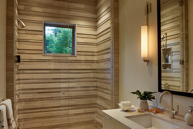 This is an example of a medium sized contemporary shower room bathroom in San Francisco with flat-panel cabinets, beige cabinets, an alcove shower, a two-piece toilet, brown tiles, beige walls, porcelain flooring, a submerged sink, wooden worktops, beige floors and a hinged door.