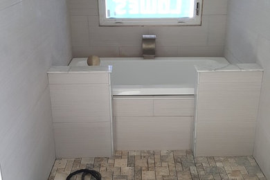 Large contemporary bathroom in Other with a built-in bath, a shower/bath combination, porcelain tiles, porcelain flooring and grey floors.