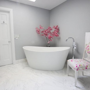 Example of a large minimalist master white tile and stone tile marble floor bathroom design in New York with beaded inset cabinets, white cabinets, a two-piece toilet, gray walls, an undermount sink and quartzite countertops
