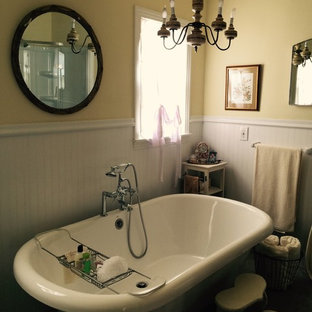 Inspiration for a mid-sized victorian master bathroom in Austin with a claw-foot tub, gray tile, ceramic floors, yellow walls, a shower/bathtub combo, an open shower, a pedestal sink and beige floor.