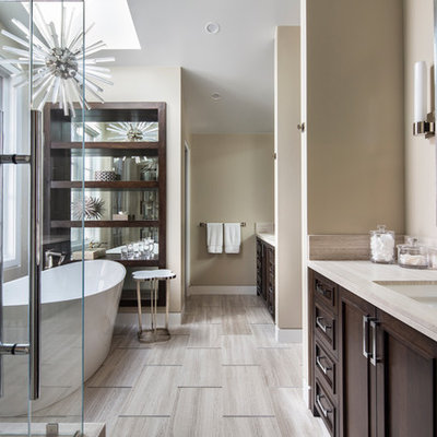 Inspiration for a mid-sized transitional master beige tile and porcelain tile porcelain tile and beige floor bathroom remodel in Orange County with beige walls, an undermount sink, a hinged shower door, recessed-panel cabinets, dark wood cabinets and beige countertops