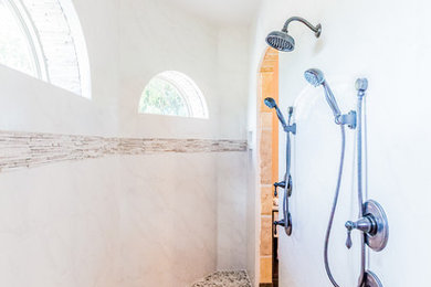 Mid-sized tuscan white tile and porcelain tile travertine floor doorless shower photo in Austin with a vessel sink, raised-panel cabinets, medium tone wood cabinets, granite countertops, a two-piece toilet and beige walls
