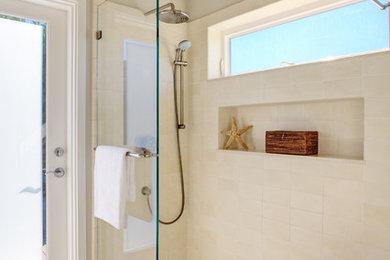 Mid-sized beach style master white tile and ceramic tile pebble tile floor walk-in shower photo in San Francisco with shaker cabinets, white cabinets, a one-piece toilet, white walls, an undermount sink and marble countertops