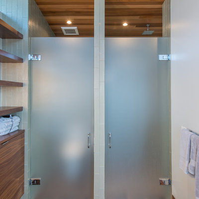 Inspiration for a small contemporary master green tile and glass tile porcelain tile and beige floor bathroom remodel in Seattle with flat-panel cabinets, brown cabinets, a one-piece toilet, green walls, an undermount sink, solid surface countertops, a hinged shower door and gray countertops