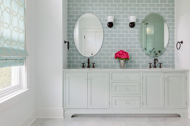 Bathroom - coastal blue tile and subway tile marble floor bathroom idea in Baltimore with blue cabinets, marble countertops, shaker cabinets and white walls